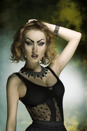 very pretty female with crazy style, bizarre purple make-up and punk dress and accessories の写真素材