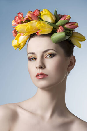 beauty close-up portrait of cute girl with floral garland on her head, cute make-up and perfect skin. Spring concept の写真素材
