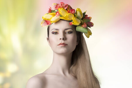 spring concept portrait of sexy woman with bared shoulders, long smooth hair and colorful make-up, wearing floral wreath on her head. Fresh style の写真素材