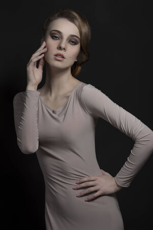 pretty young girl in fashion portrait with elegant gray dress and classic hair-style. Romantic eyes の写真素材