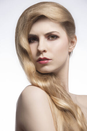 close-up portrait of young blonde girl with elegan tvery long hairdo, cute shiny hairの写真素材