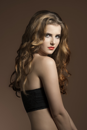 very pretty young girl with long wavy hair, cute make-up  の写真素材