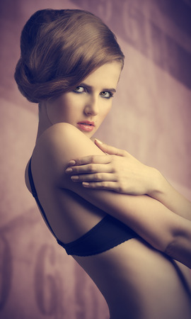 portrait of very sexy young woman in fashion pose with elegant hair-style, black bra and stylish make-up の写真素材