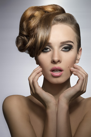 beauty portrait of pretty girl with elegant hair-style and stylish make-up, perfect skin, naked shoulders の写真素材
