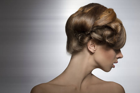 beauty shoot of sexy girl with elegant creative hair-style, her visage is turned on right の写真素材