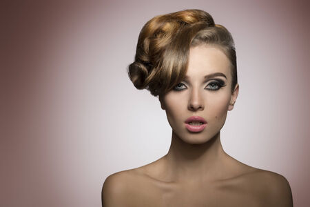 beautiful lady with creative elegant hair-style and fashion make-up in close-up portrait の写真素材