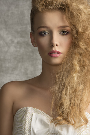 fashion close-up portrait of very pretty young woman with curly creative hair-style, colorful make-up and elegant sexy dressの写真素材