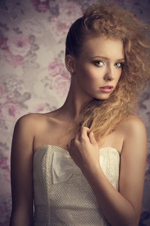 fashion portrait of charming young female with creative stylish hair-style, colorful make-up and elegant white dressの写真素材