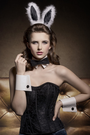 sexy easter pin-up with fluffy bunny ears and corset, glamour shootの写真素材