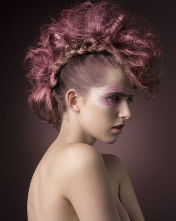 beauty portrait of cute woman with perfect skin and naked body posing with punk hair-style and make-up. Aggressive fashion styleの写真素材