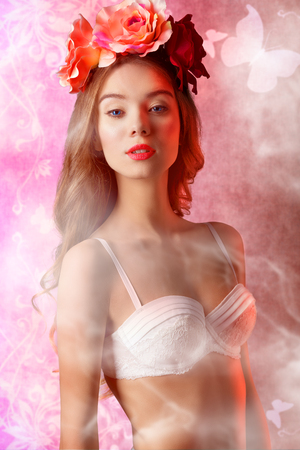 Beautiful, natural, retro, spring woman in white bra and flowers on the head, with long curly hair.の写真素材
