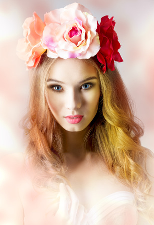 Spring, beautiful, charming woman in white bra and flowers on her head, she has got long, curly hair and natural make up.の写真素材