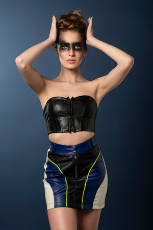 sexy girl in leather fit outfit, in punk dark style, she has black make up on her face, and striped color gownの写真素材