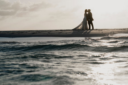 Latin spouses celebrating their wedding on the beachの写真素材
