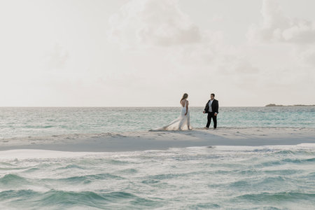 Latin spouses celebrating their wedding on the beachの写真素材