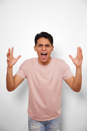 angry young man on white backgroundの写真素材