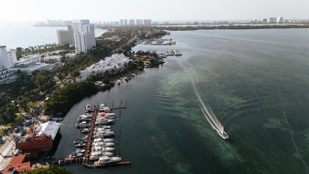 Boat sailing at a beautiful sunrise on the waters of the Cancun lagoon in the hotel zone.の写真素材