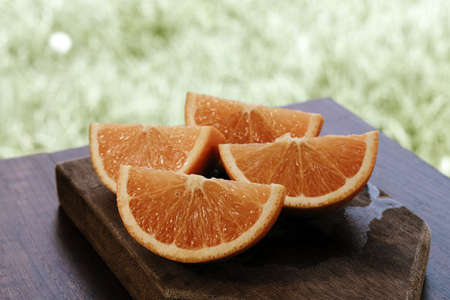 sweet Chilean orange, cut on a wooden board to be servedの写真素材
