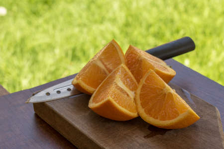 sweet Chilean orange, cut on a wooden board to be servedの写真素材