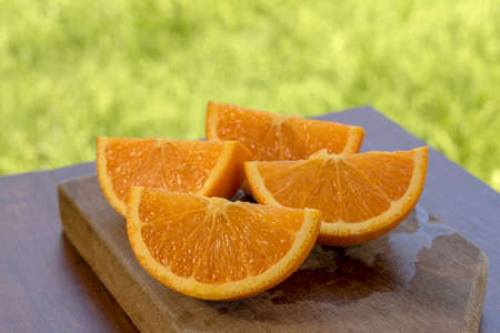sweet Chilean orange, cut on a wooden board to be servedの写真素材