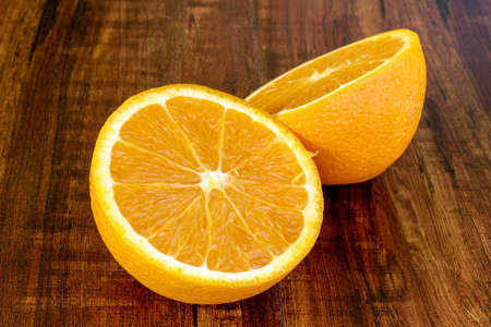 sweet Chilean orange, cut on a wooden board to be servedの写真素材
