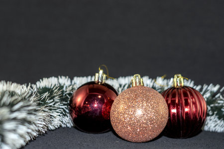 Christmas balls and tinsel on a black background with copy space.の写真素材