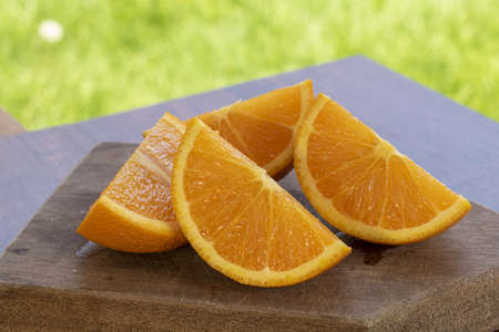 sweet Chilean orange, cut on a wooden board to be servedの写真素材