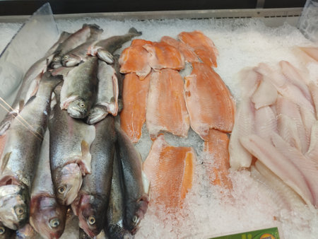 Variety of fresh fish on ice in the market. Top view.の写真素材