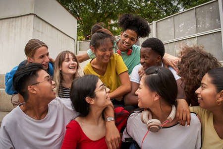 A group of students having fun outside. Happy classmates at the high school. Back to school together again.の写真素材