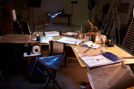 Creative artist workplace room no people hobby. Interior of contemporary arts studio with unfinished picture and painting stuff near byの写真素材