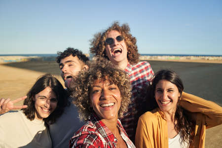 Multiracial group of young people taking selfie and having fun.