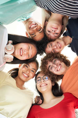 Vertical photo of a multiracial group of friends taking a selfie - New concept of normal friendship...