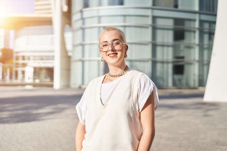 Happy shaved hair woman looking at the camera outdoorsの写真素材