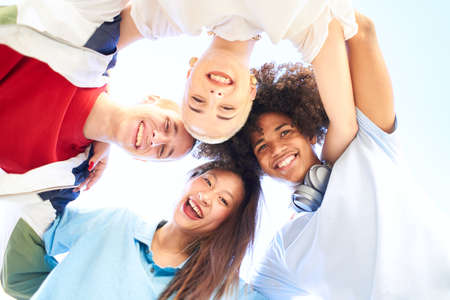 Happy multiracial friends having fun together. Group of smiling people looking at camera. Teenagers young students community and friendship lifestyle conceptの写真素材