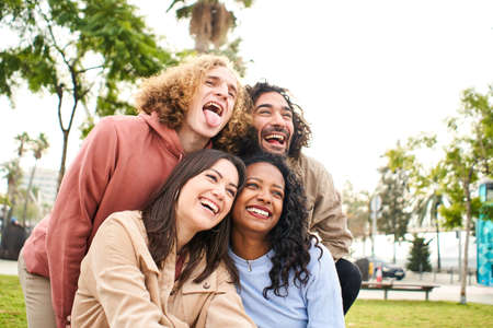Happy friends from diverse cultures and races taking photo making funny faces - Youth, millennial generation and friendship conceptの写真素材