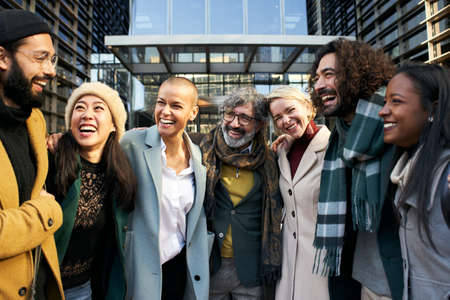 Business team working smiling portrait, talking and laughing. Man and women outdoors together in...