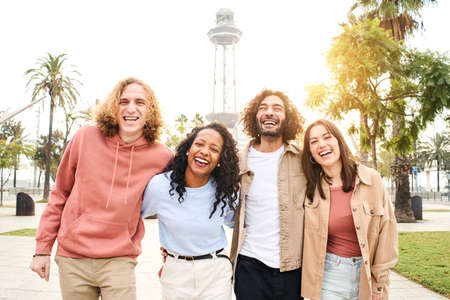 Selfie of Group of young cheerful people looking at the camera outdoors. Happy smiling couples hugging and having fun. Concept of community and youth lifestyleの写真素材