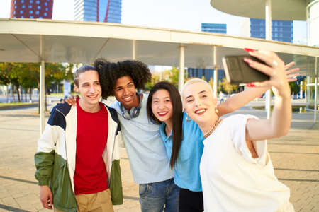 Happy centennial people taking smiling selfie. Group of students together at campus university