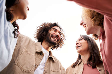 Happy young people embracing and having a fun. Smiling cheerful friends.