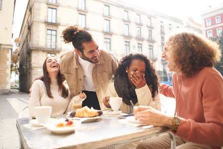 People group talking at coffee bar terrace. Friends having fun together at cafeteria on brunch time....
