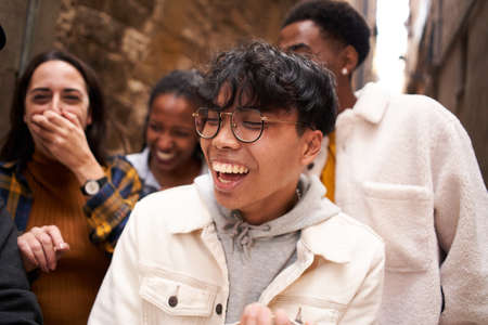 Asian guy with a Group of happy multiethnic friends laughing. People having fun outdoorの写真素材