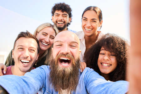 Cheerful Group of friends posing for a photo and having fun. Friendship and community conceptの写真素材