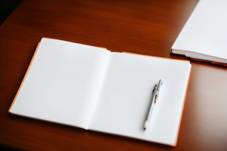 Blank notebook and pen on wooden table background, business concept.の素材