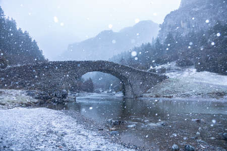 Romanesque bridge of Bujauelo under a snowfall
