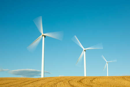 Wind farm, modern windmills on a bright and sunny dayの写真素材