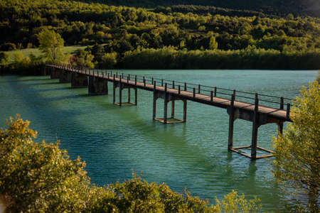Old bridge over the river in the forestの写真素材