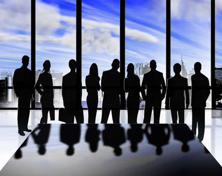 Silhouettes of men and women in businessの写真素材