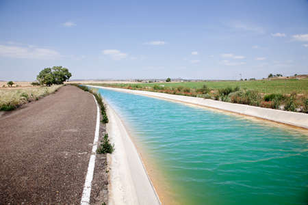 Landscape with road and water channelの写真素材