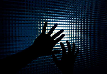 Hands of one person trying to get outの写真素材