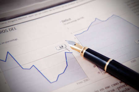 Business background with graphics and penの写真素材